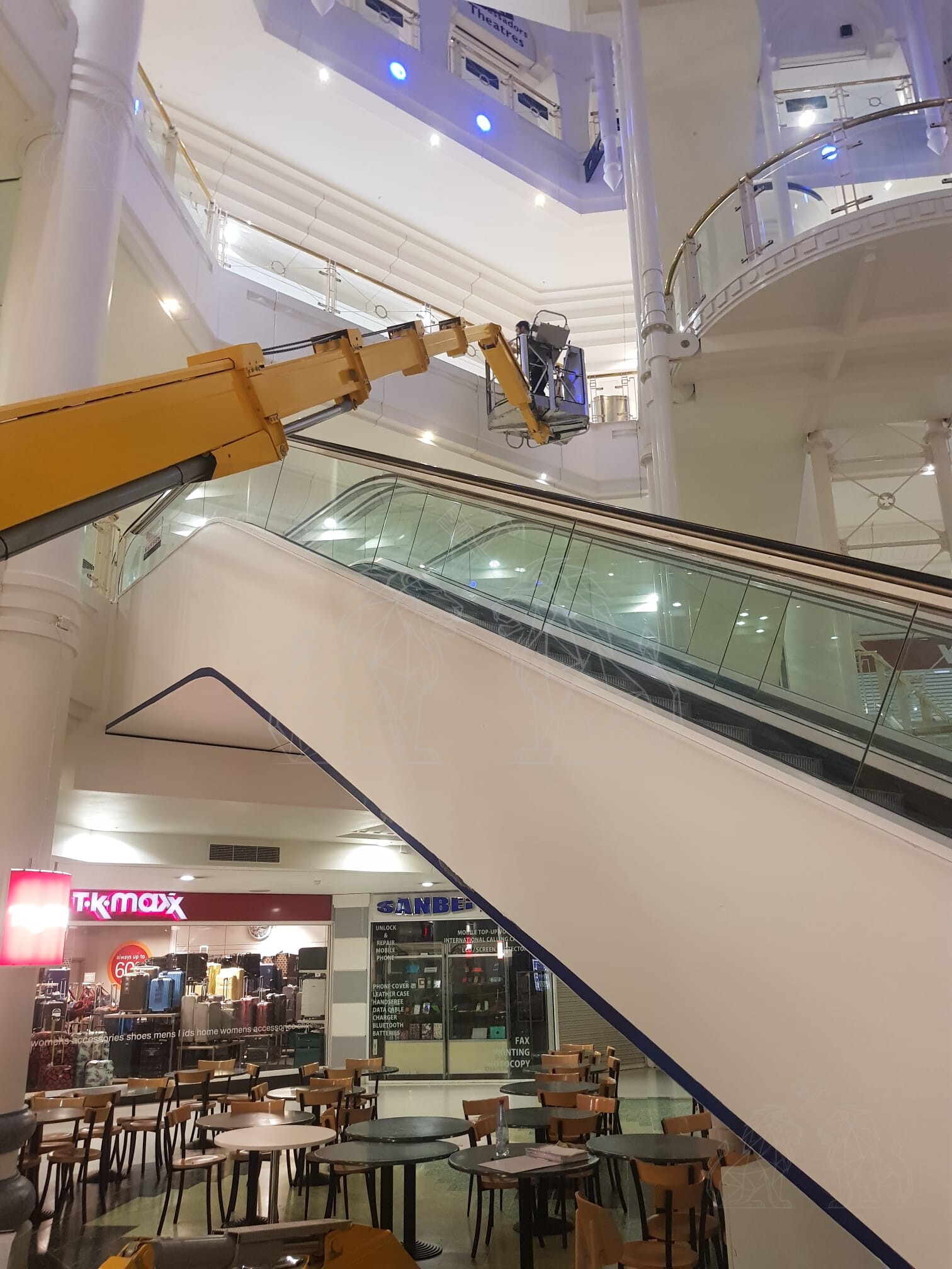 Telescopic MEWP positioned around escalators for difficult-to-reach commercial works